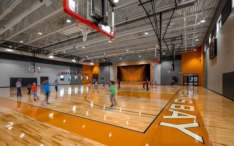 Children playing basketball at Williams Bay Elementary School, an educational construction project designed and built by Scherrer Construction in Wisconsin, USA. 