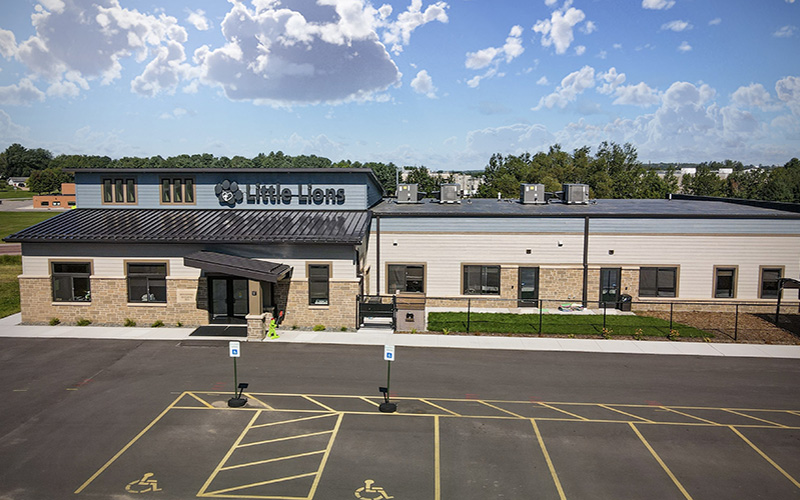 View of exterior of childcare building and parking lot